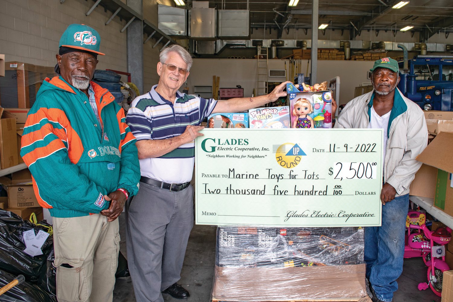 Left to right: Duke Williams, Joe Hosick, and Johnnie Marshall accept a check for Marine Toys for Tots. Joe has served as the coordinator for Toys for Tots in Glades and Hendry counties for 11 years. Duke and Johnnie have been faithful volunteers and have assisted Joe with this program.